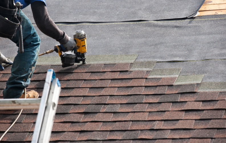 A roofer installing a new roof