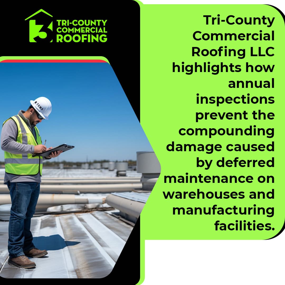 A commercial roofing inspector on a warehouse roof documenting an annual inspection to help prevent compounding damage from deferred maintenance.